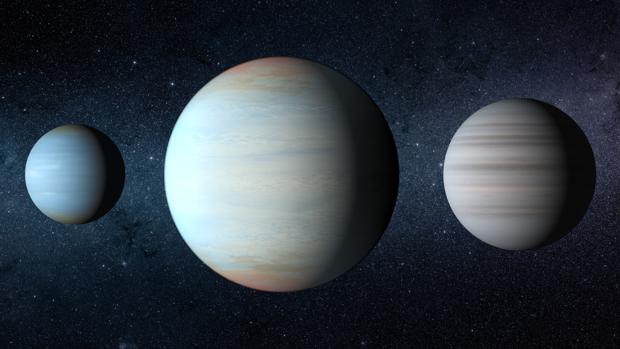 Recreación artística de los tres planetas del sistema Kepler-47. El gran planeta del medio es el recién descubierto